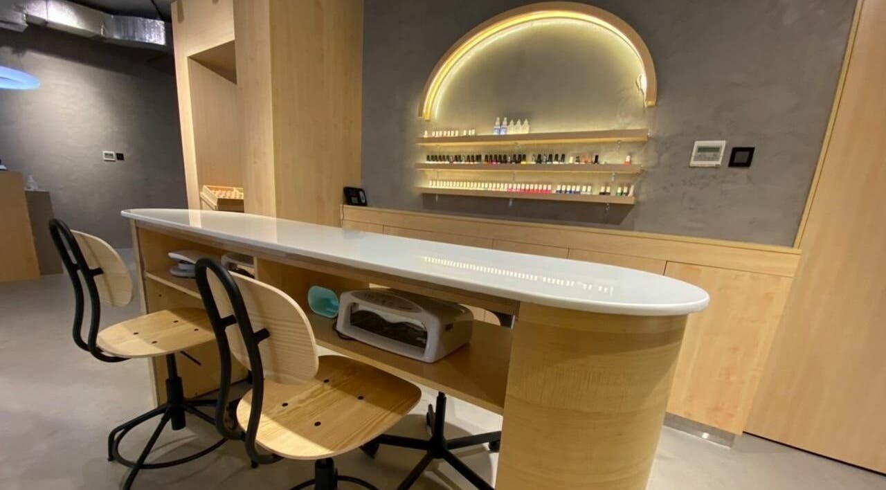 Chic nail bar at Raw Beauty Salon in Abu Dhabi, AE featuring elegant chairs and modern styling.