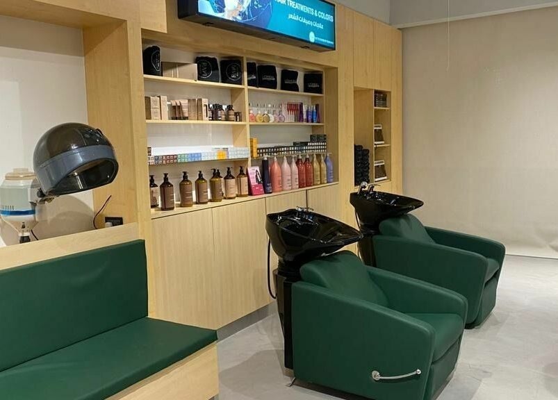 Modern salon interior at Raw Beauty Salon, Abu Dhabi, AE, featuring sleek shampoo stations.