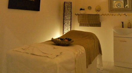 Relaxing massage room at Evaiya Spa, Surfers Paradise, Queensland, AU, with dim lighting and calming decor.