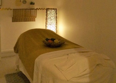 Peaceful massage room at Evaiya Spa, Surfers Paradise, Queensland, AU, with ambient lighting and cozy linens.