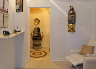 Elegant lounge with statues at Evaiya Spa, Surfers Paradise, Queensland, AU, offering tranquil atmosphere.