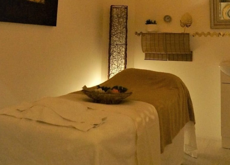 Cozy massage room at Evaiya Spa, Surfers Paradise, Queensland, AU with soft lighting and warm decor.
