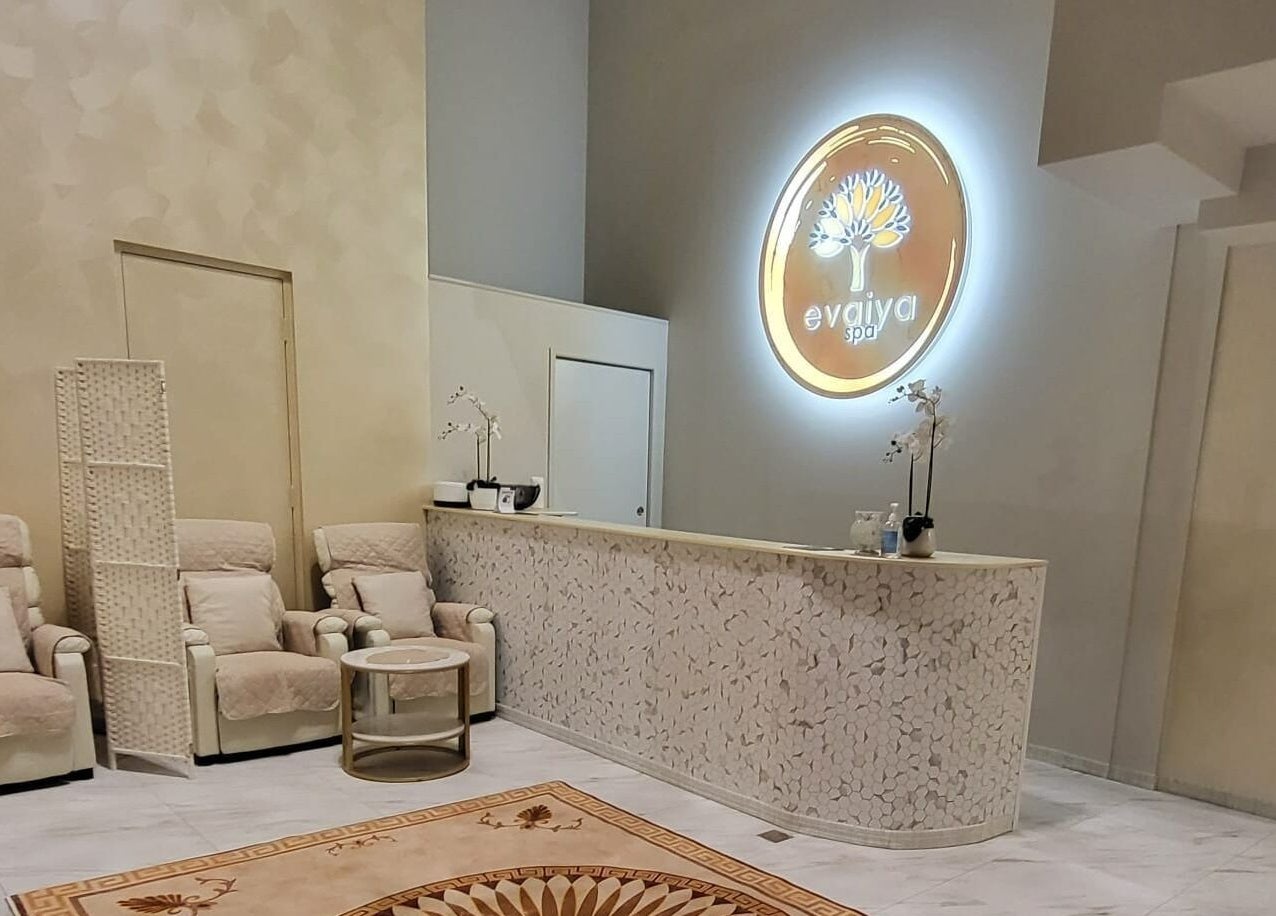 Serene reception area of Evaiya Spa, Surfers Paradise, Queensland, AU with cozy chairs and elegant decor.