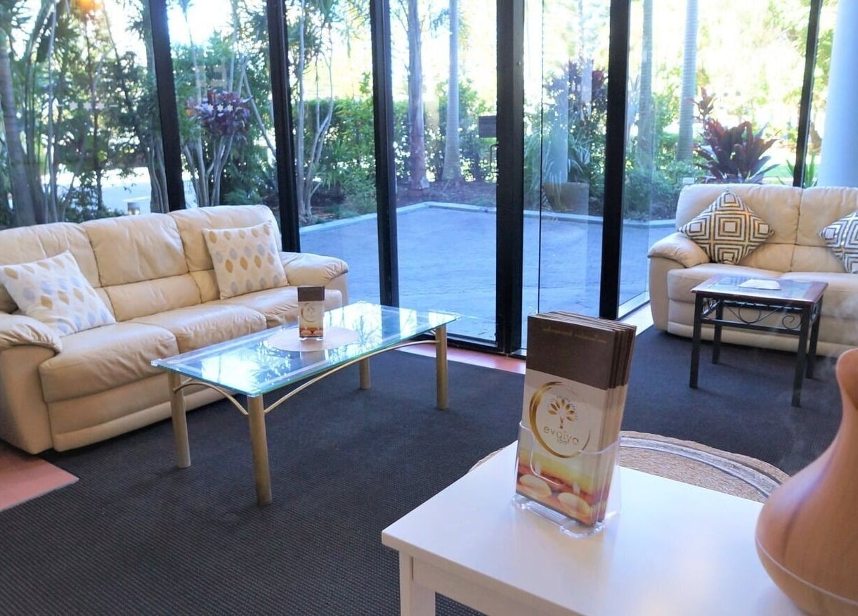 Relaxing lounge area at Evaiya Spa, Surfers Paradise, Queensland, AU, featuring comfortable seating and greenery.