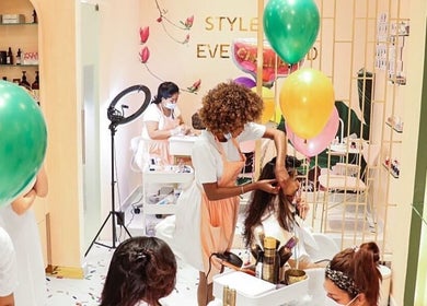 Cuts and Nails Beauty Salon - Home Service in Dubai, AE, featuring stylists working with clients in a vibrant setting.