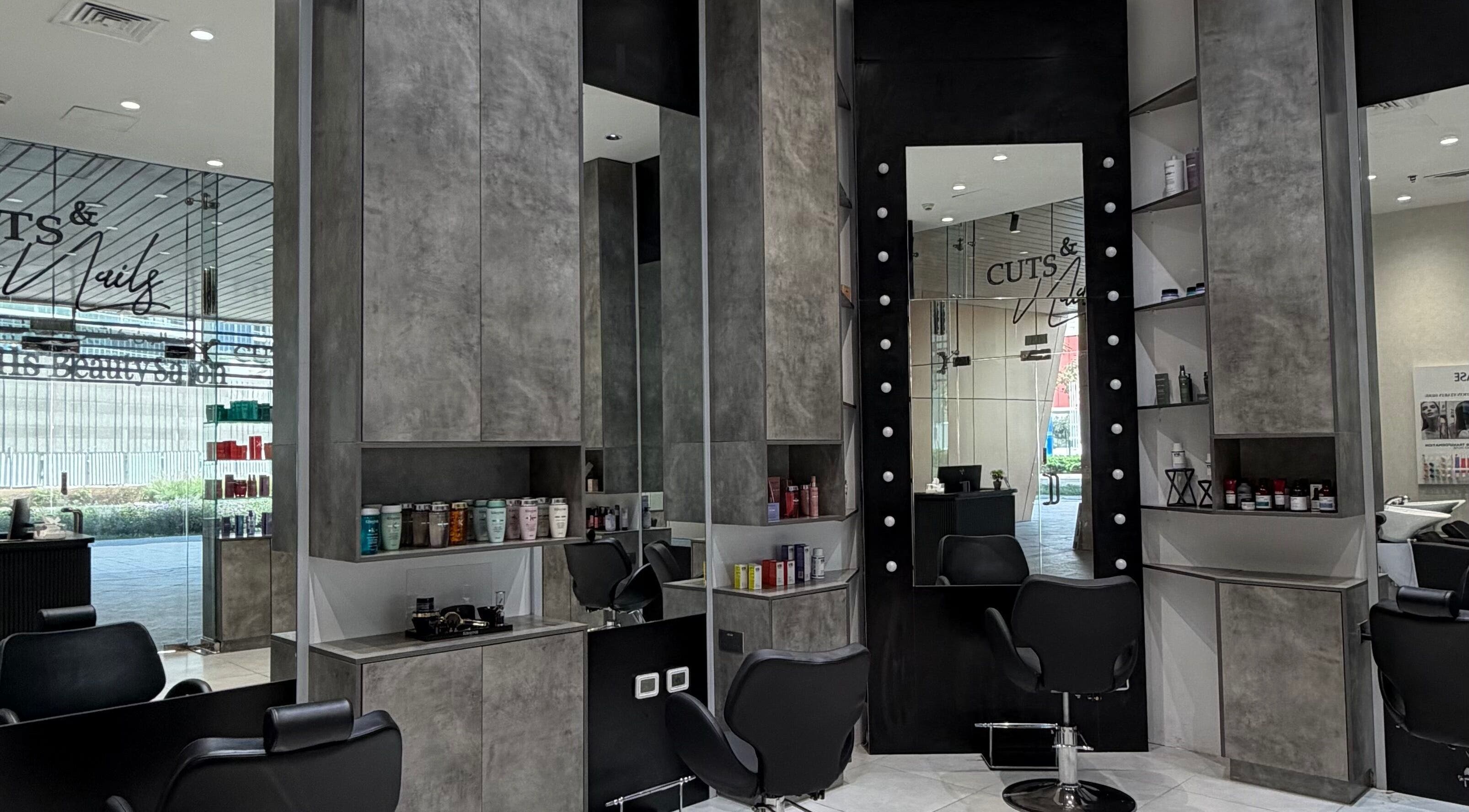 Chic interior of Cuts and Nails Beauty Salon in Dubai, AE showcasing styling stations and product display.
