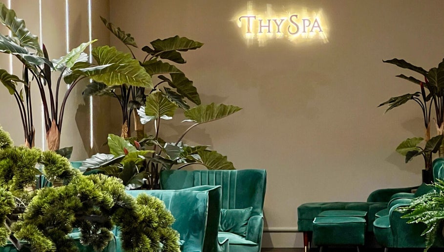 Elegant green seating and lush plants at Thy Spa Bath, Bath, England, GB create a tranquil ambiance.