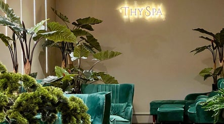 Elegant green seating and lush plants at Thy Spa Bath, Bath, England, GB create a tranquil ambiance.