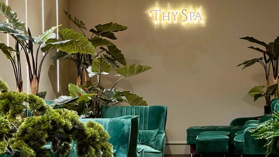 Elegant green seating and lush plants at Thy Spa Bath, Bath, England, GB create a tranquil ambiance.