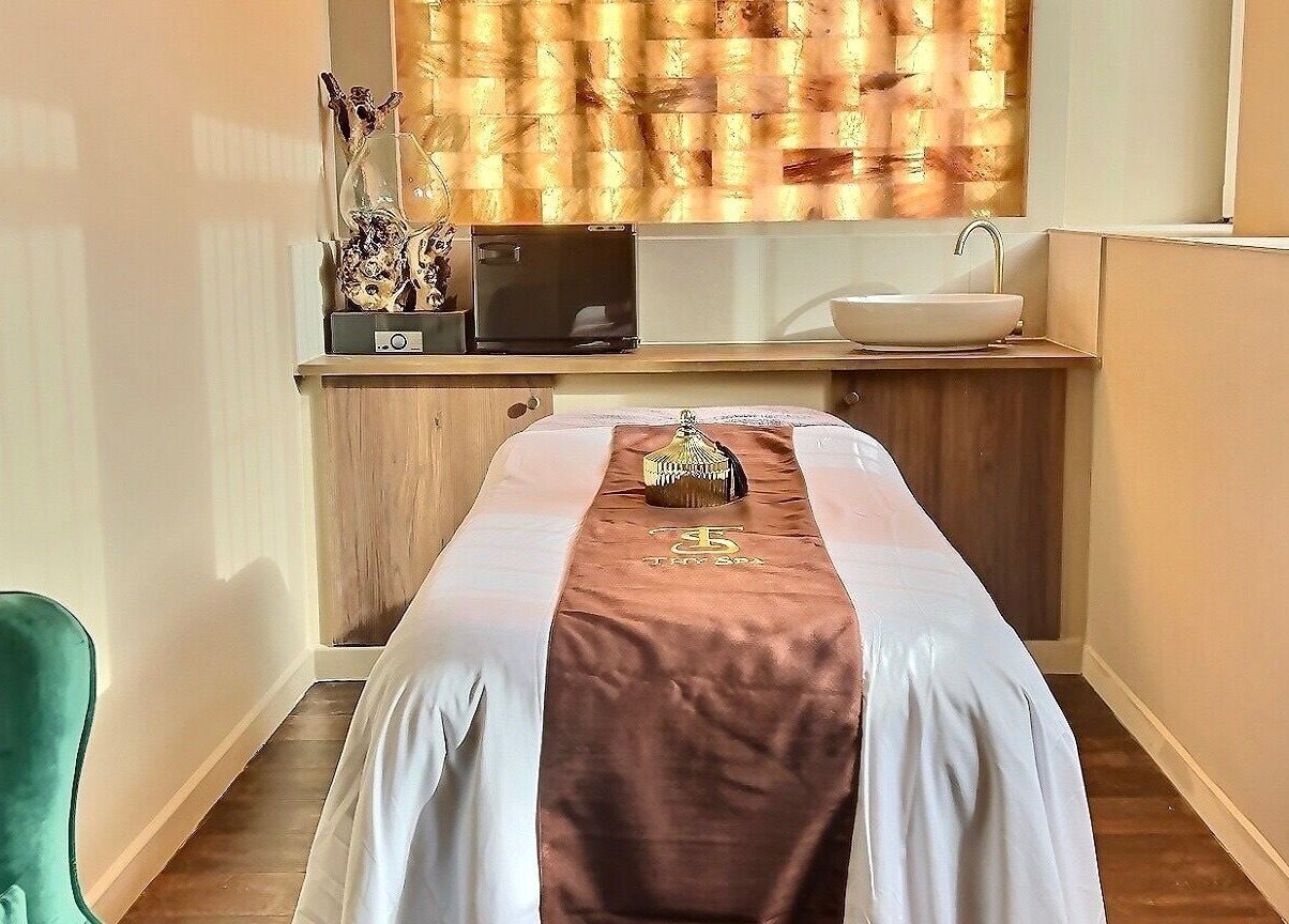 Relaxing spa room at Thy Spa Bath in Bath, England, GB, featuring a cozy massage table and serene ambiance.