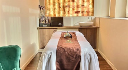 Relaxing spa room at Thy Spa Bath in Bath, England, GB, featuring a cozy massage table and serene ambiance.