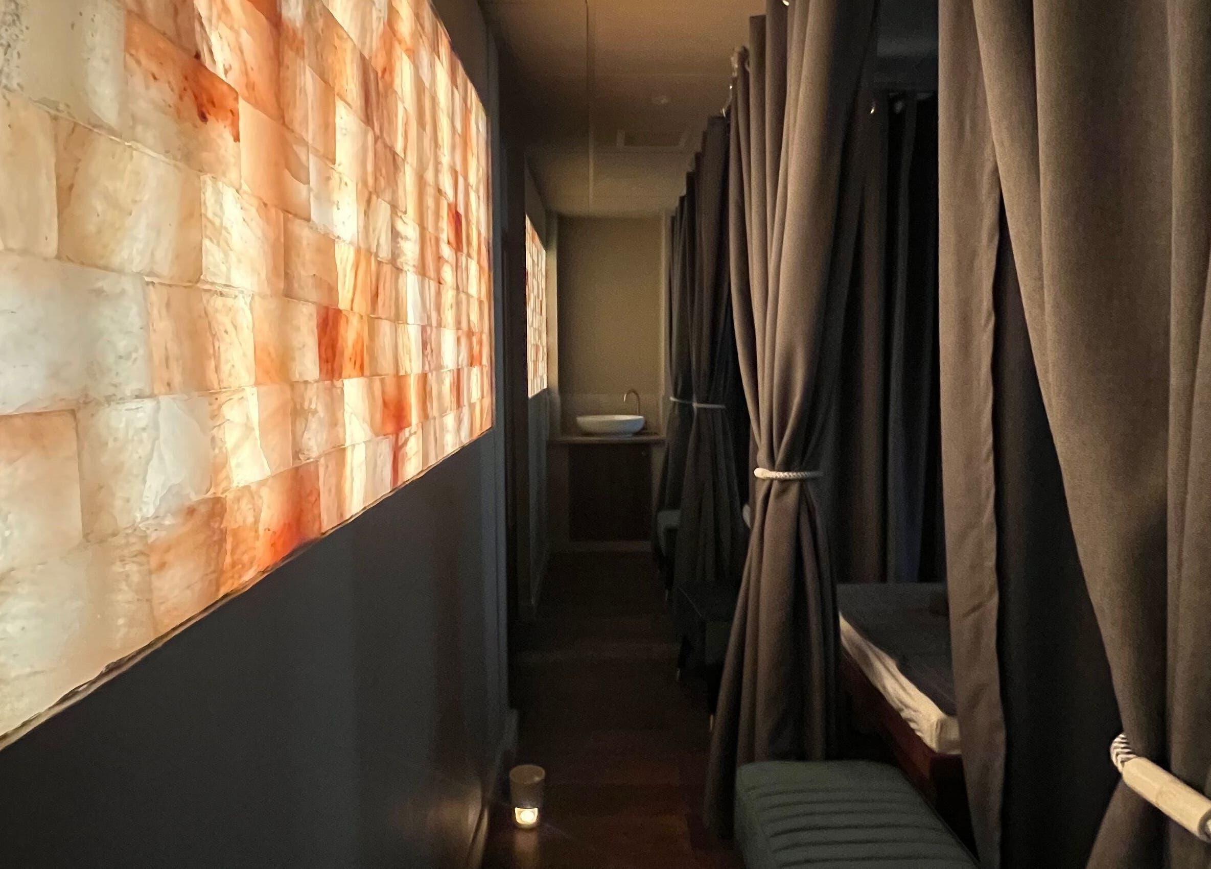Relaxing corridor at Thy Spa Bath, Bath, England, GB with ambient lighting and cozy curtains.