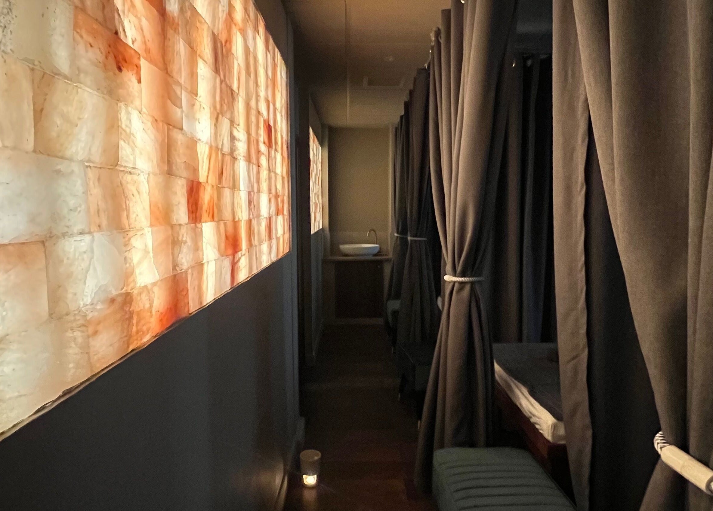 Relaxing corridor at Thy Spa Bath, Bath, England, GB with ambient lighting and cozy curtains.