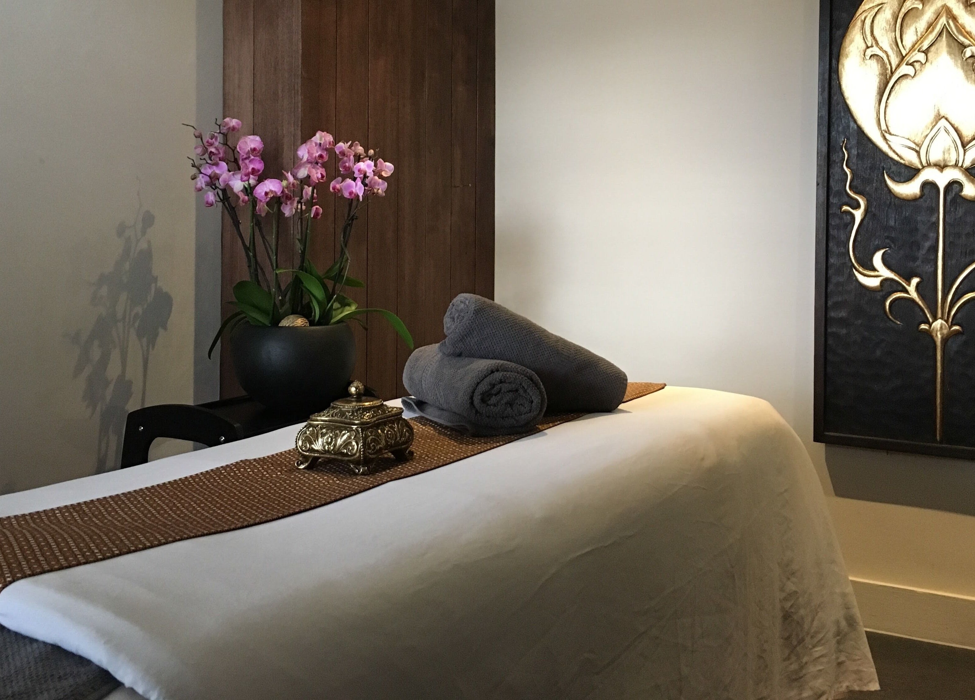 Calming massage room at Thy Spa Oxford, featuring plush towels and elegant decor in Oxford, England, GB.