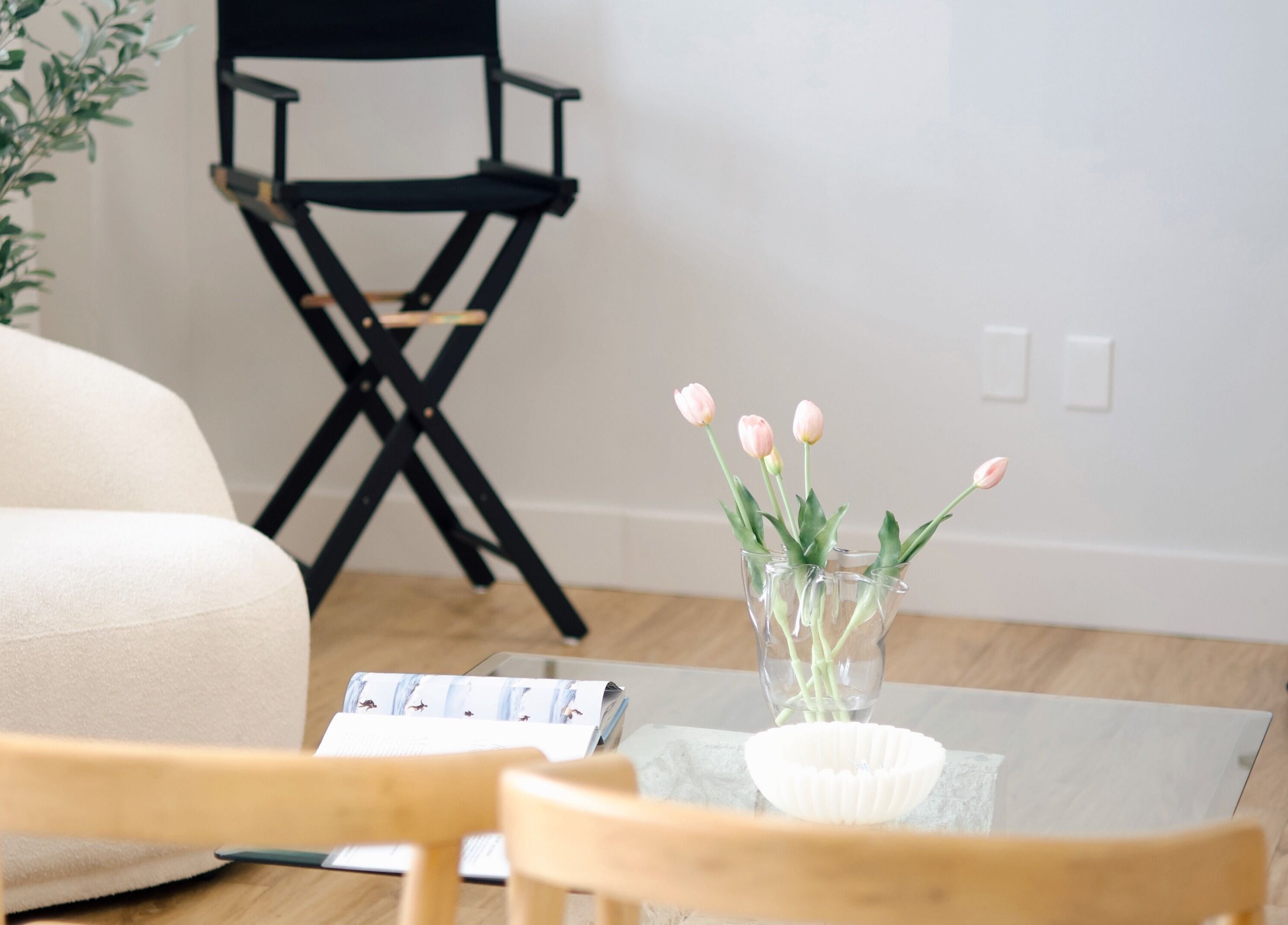 Relaxing seating area at Sand + Sol Studio, Rogers, Arkansas, US with chairs and tulips.