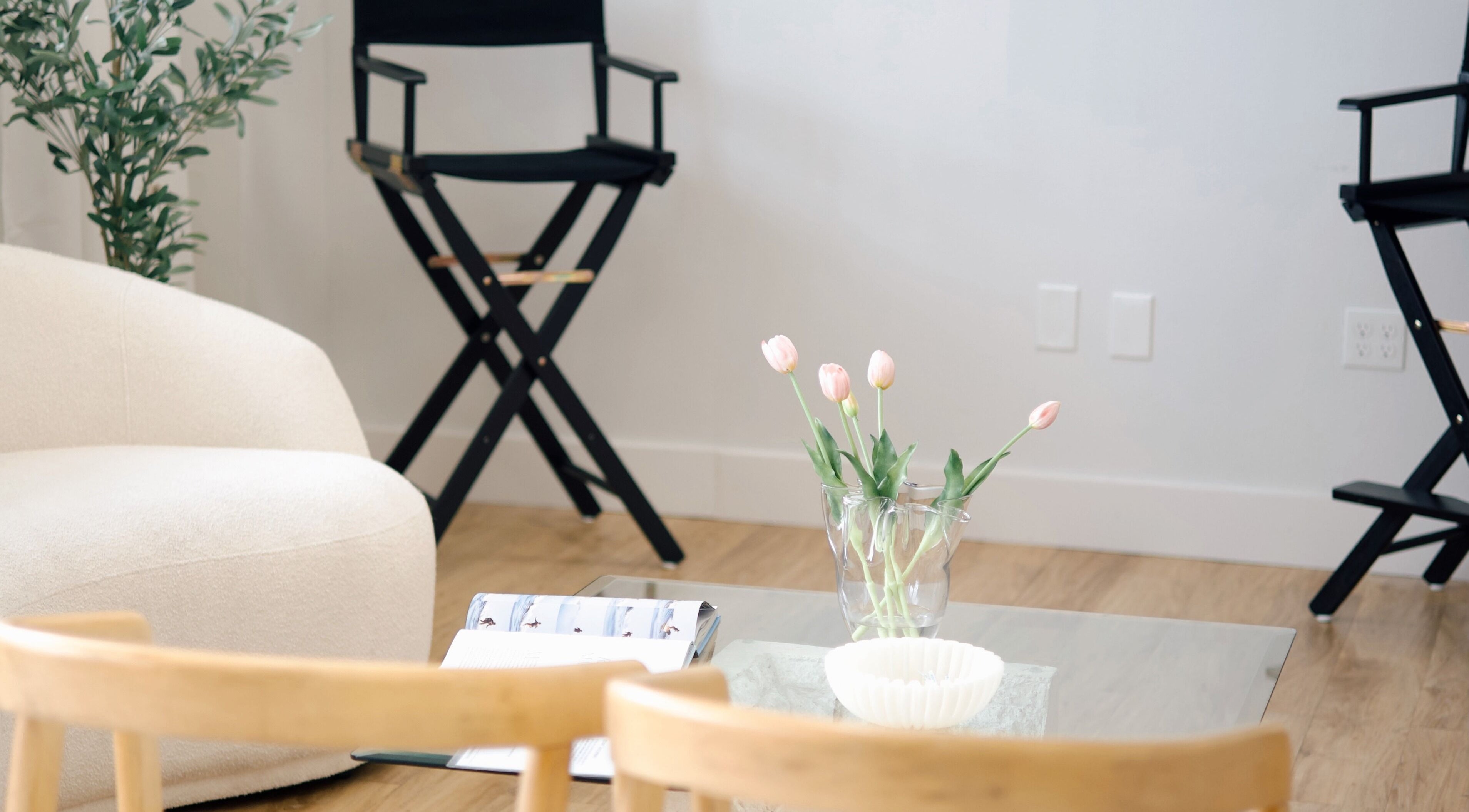 Relaxing seating area at Sand + Sol Studio, Rogers, Arkansas, US with chairs and tulips.