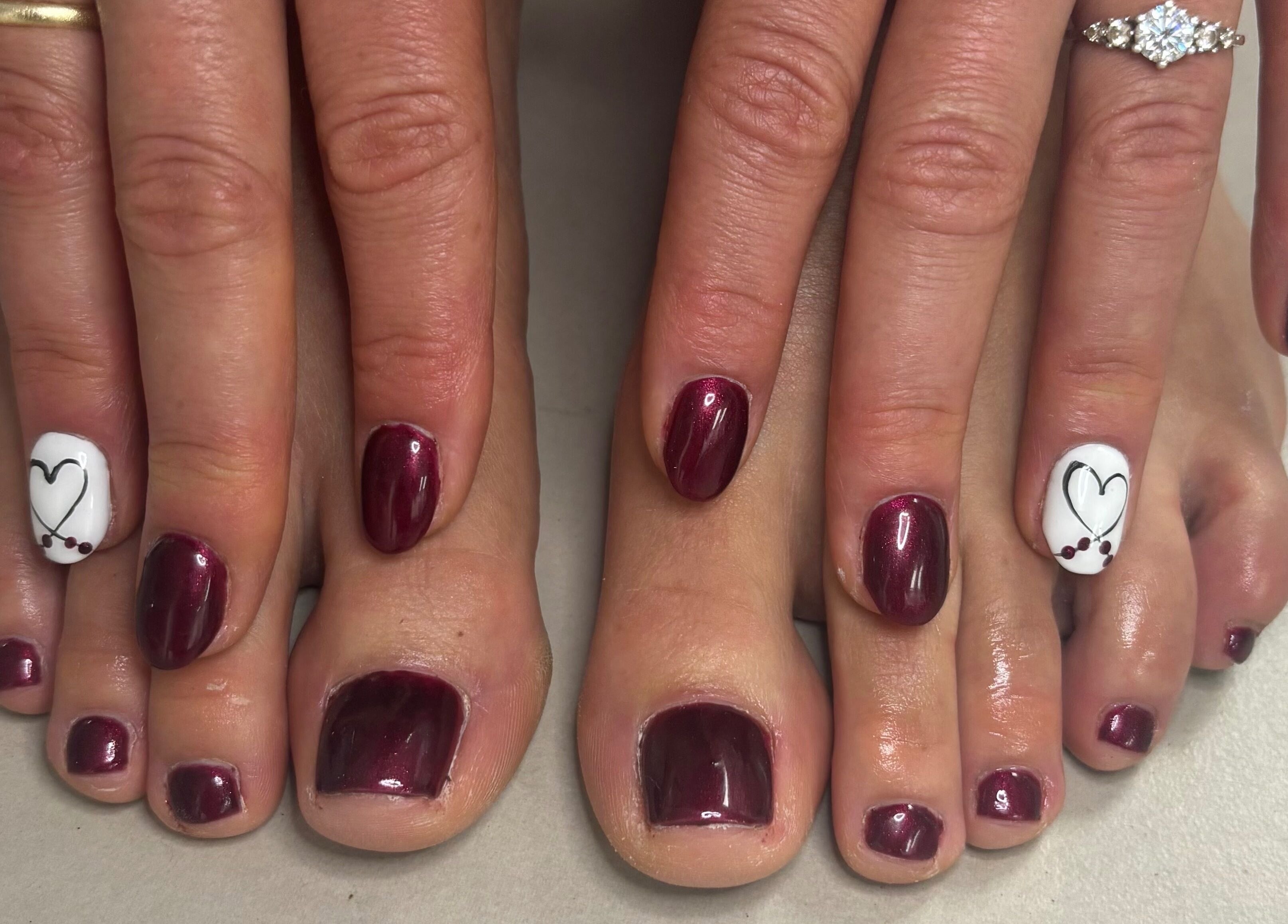 Stylish burgundy nails with heart art at Salon Beautè, Hillcrest, Kwazulu-natal, ZA.