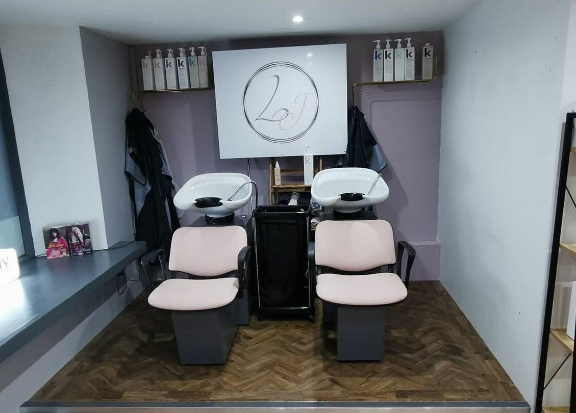 Hair washing area at Lucy Jorge in Langport, England, GB with stylish chairs and products.