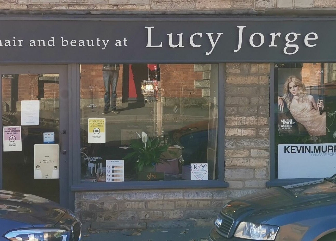Lucy Jorge's elegant salon facade featuring beauty posters in Langport, England, GB.