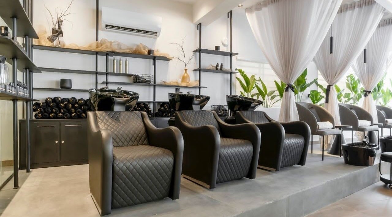 Chic salon interior at My Extensionz, Lagos, NG, featuring luxurious seating and stylish decor.