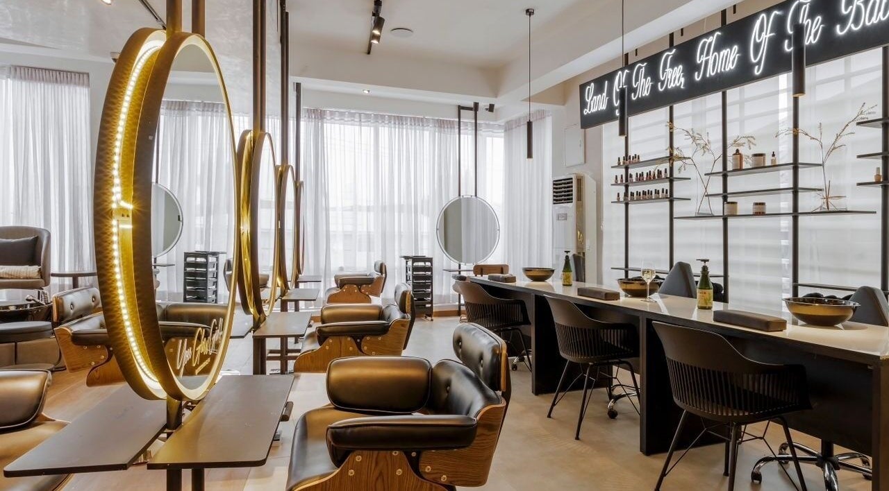 Elegant beauty salon interior at My Extensionz, Lagos, Lagos, NG, featuring luxurious seating and warm lighting.