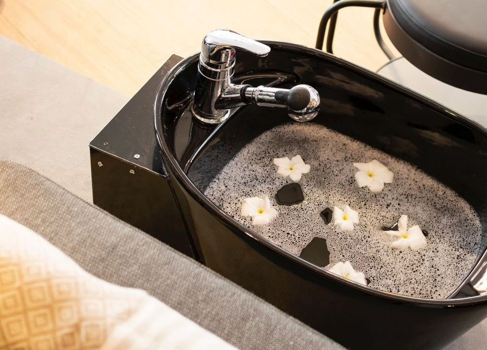 Relaxing pedicure tub with floating flowers at My Extensionz, Lagos, Lagos, NG, for a serene spa experience.