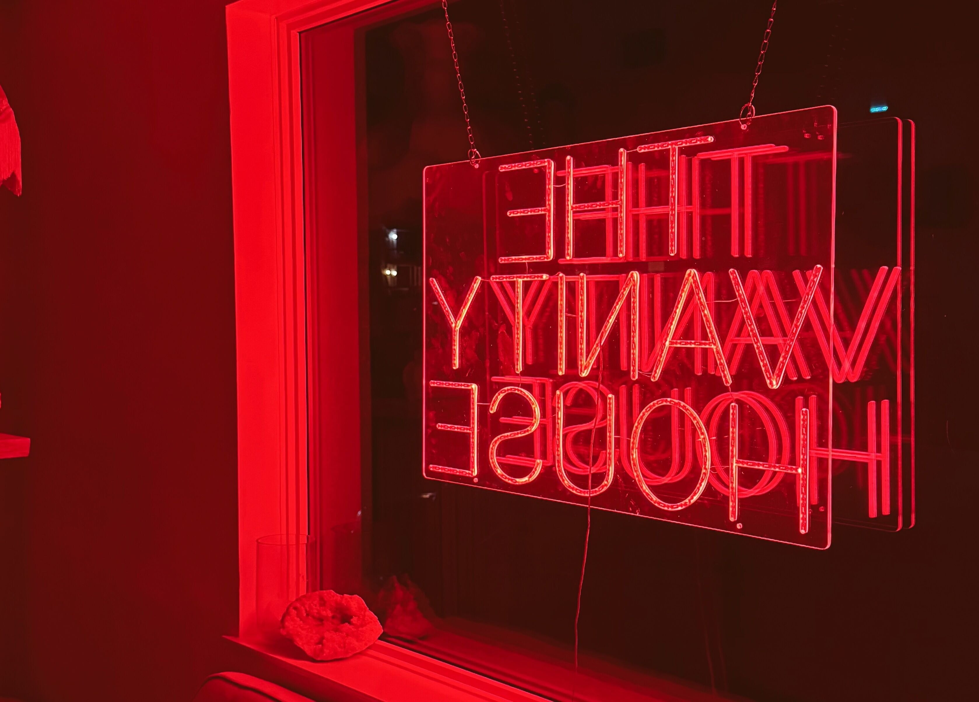 Cozy red neon ambiance at Enhance Esthetics, Baltimore, Maryland, US, highlighting a chic and inviting atmosphere.