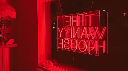 Cozy red neon ambiance at Enhance Esthetics, Baltimore, Maryland, US, highlighting a chic and inviting atmosphere.