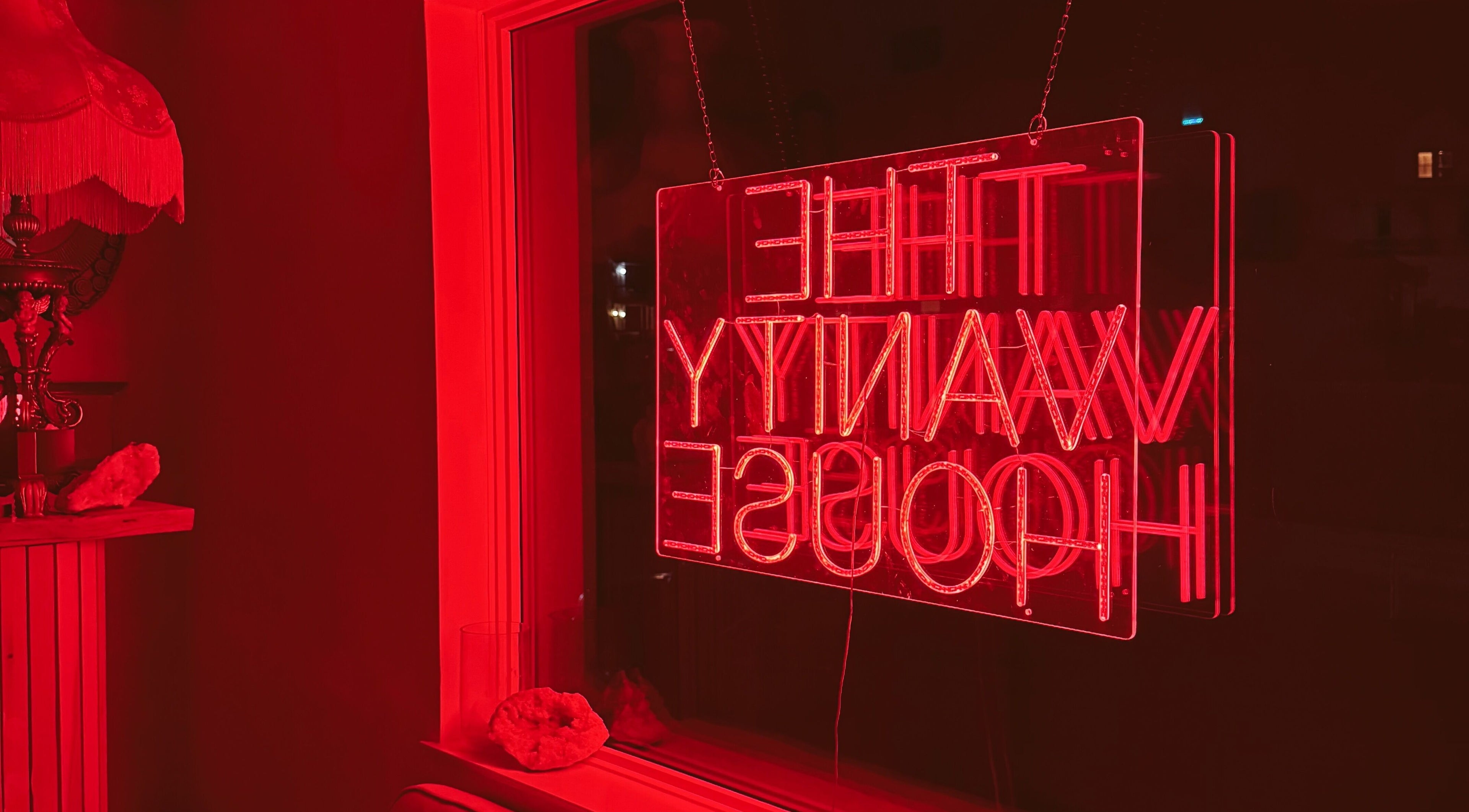 Cozy red neon ambiance at Enhance Esthetics, Baltimore, Maryland, US, highlighting a chic and inviting atmosphere.