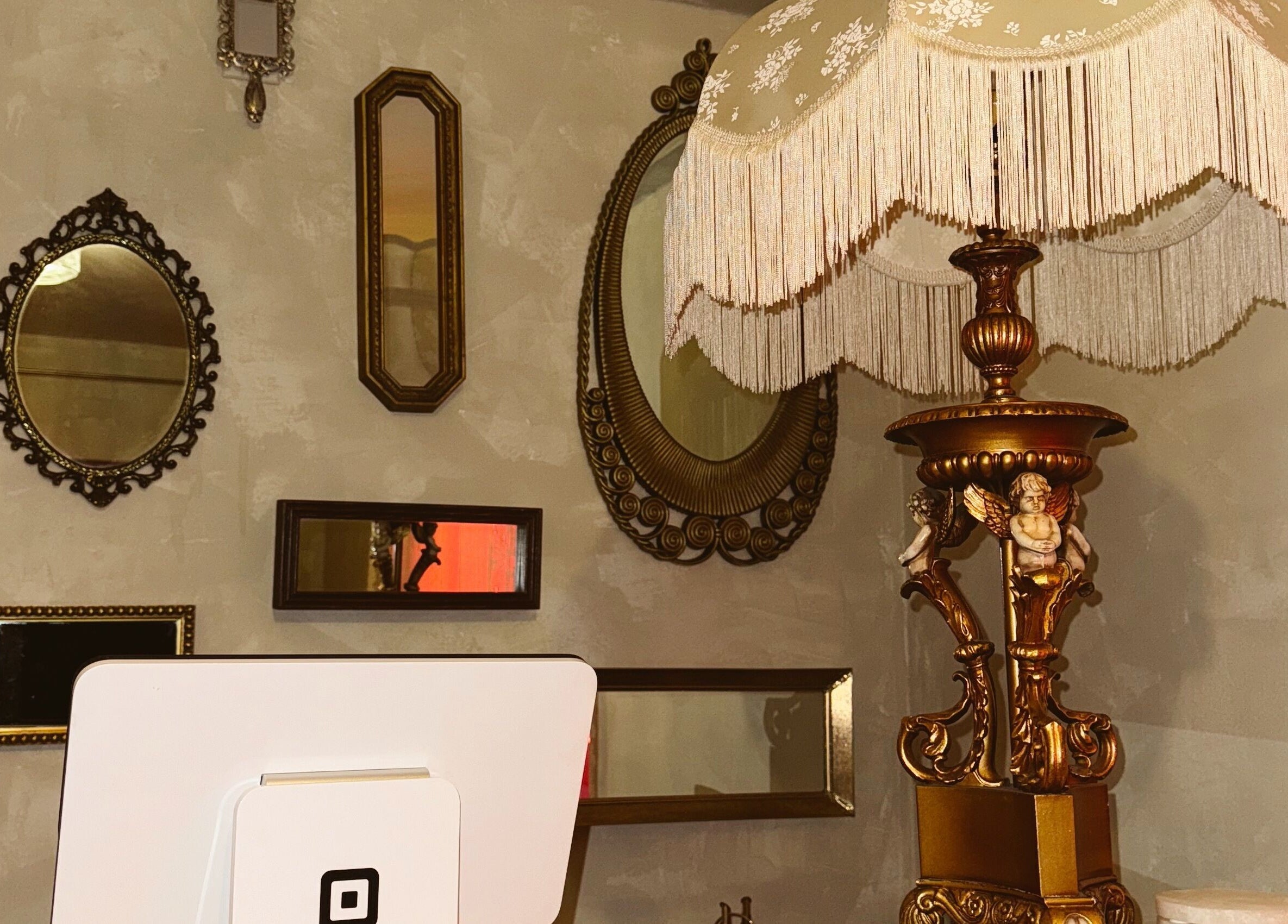Vintage lamp and ornate mirrors at Enhance Esthetics, Baltimore, Maryland, US.