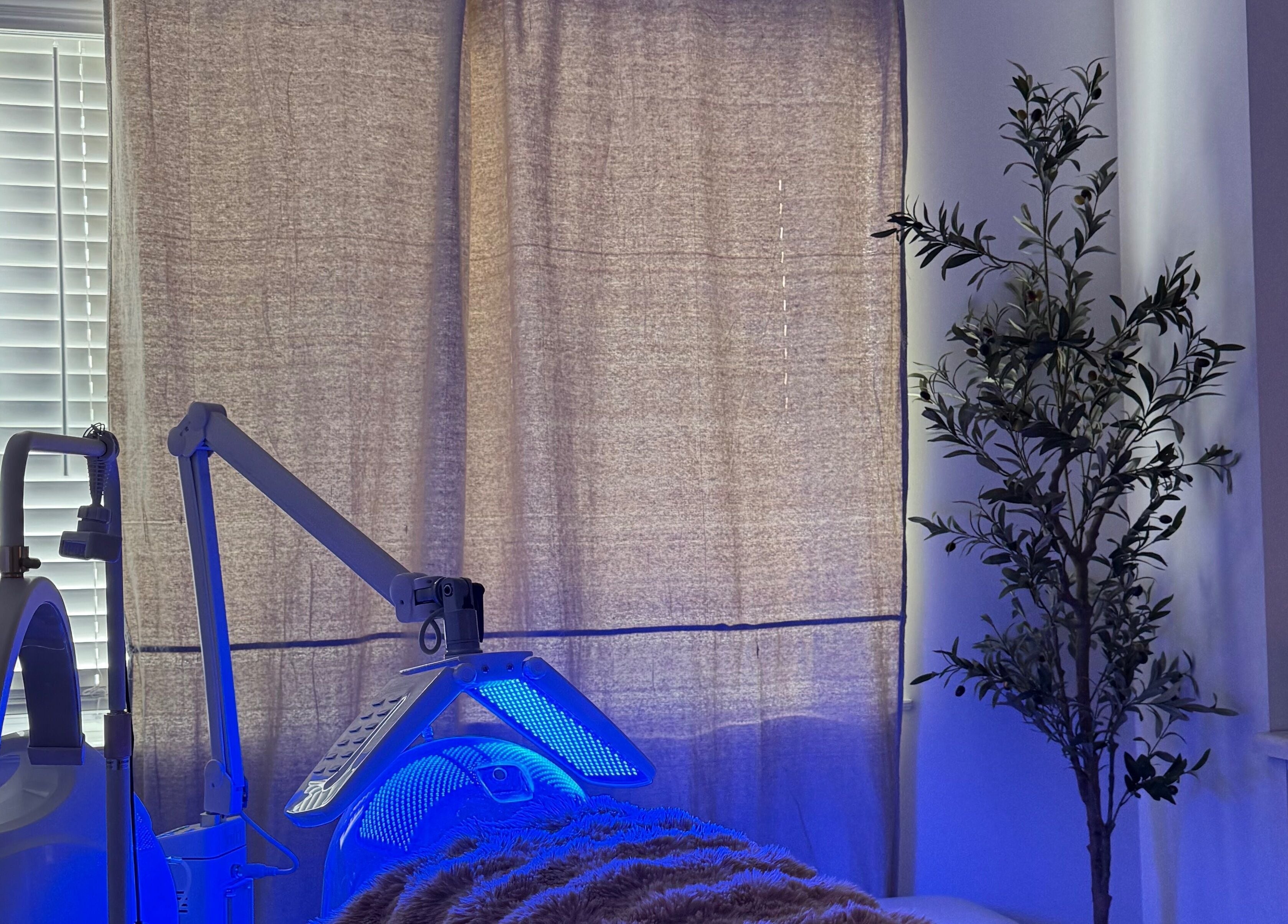 Calming treatment room at Enhance Esthetics, Baltimore, Maryland, US with modern equipment and tranquil lighting.