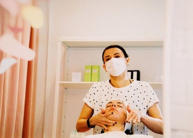 Skincare treatment at Elevate in Glasgow, Scotland, GB. Aesthetician provides facial care in a serene setting.