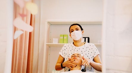 Skincare treatment at Elevate in Glasgow, Scotland, GB. Aesthetician provides facial care in a serene setting.