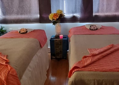 Tranquil massage room at Sala Thai Massage Takapuna in Auckland, Auckland, NZ with two beds and floral decor.