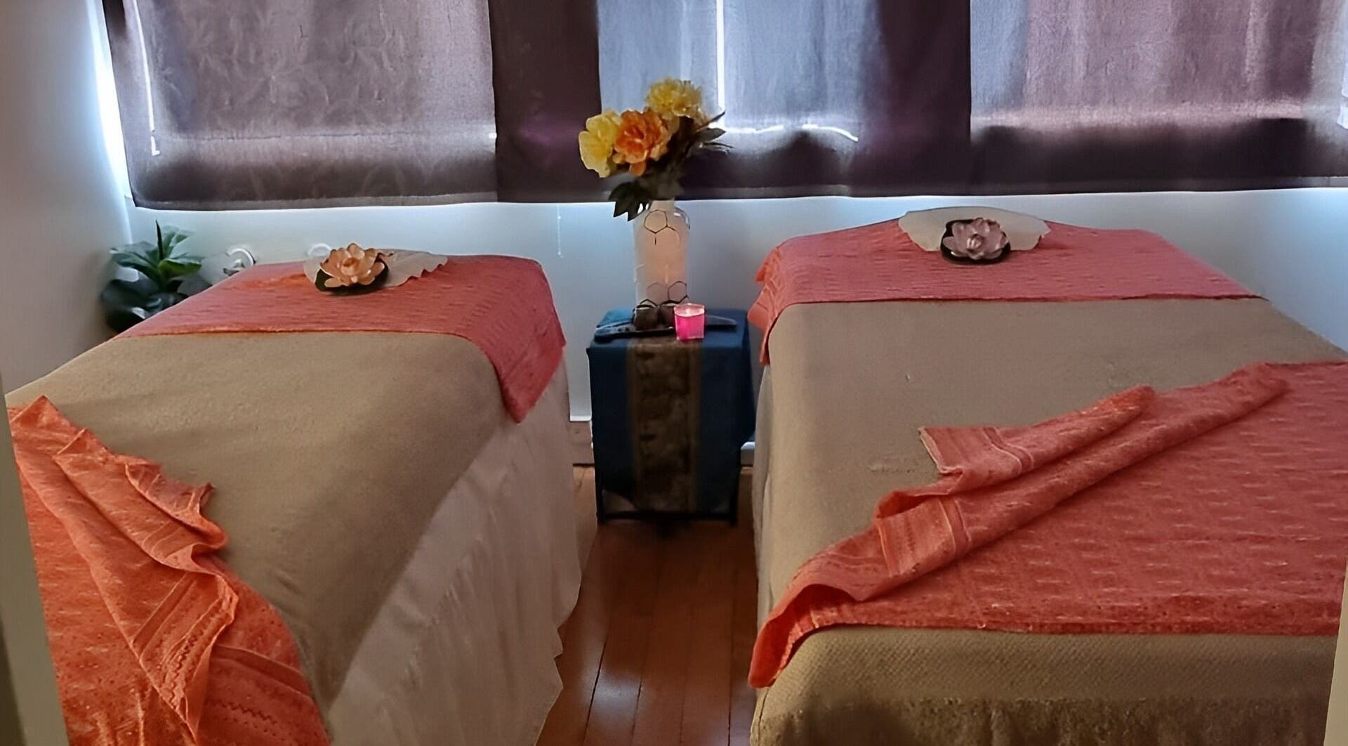 Tranquil massage room at Sala Thai Massage Takapuna in Auckland, Auckland, NZ with two beds and floral decor.