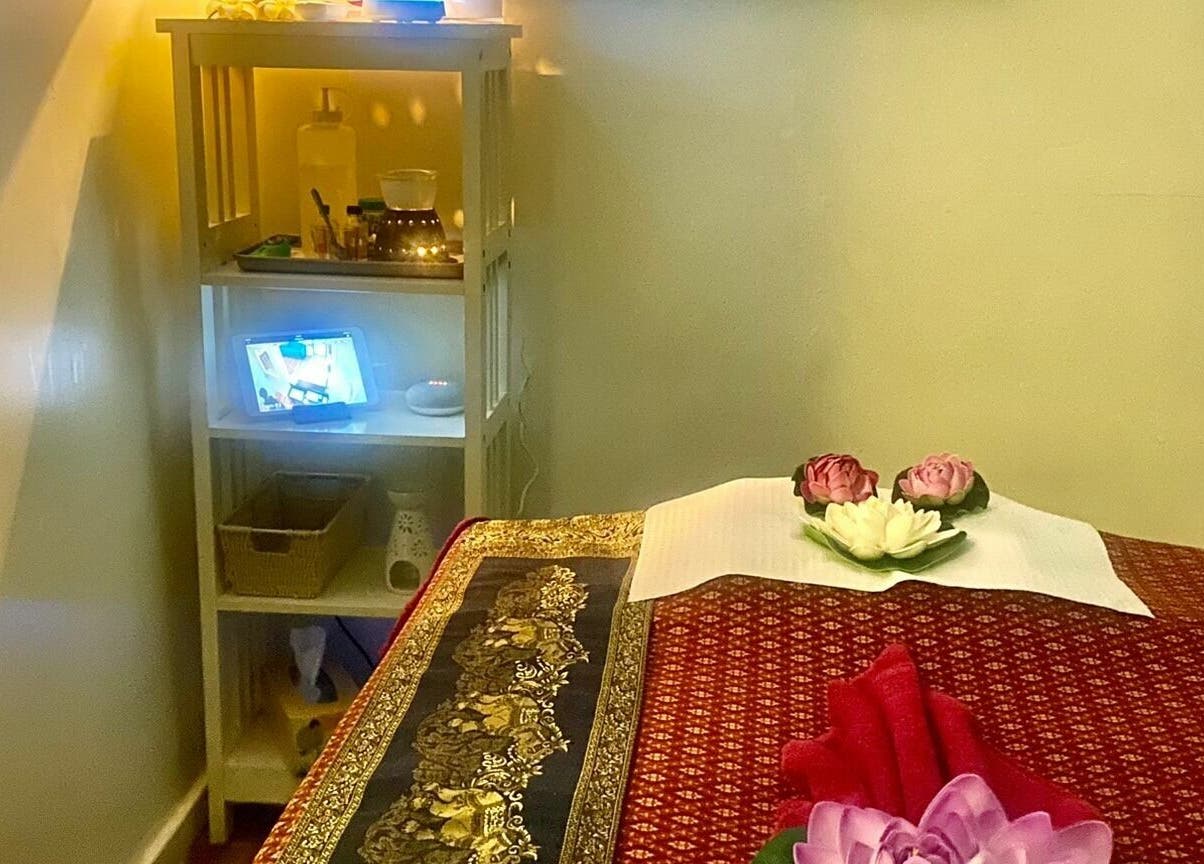 Relaxing treatment room at Sawadee Hamilton in Hamilton, New South Wales, AU with decorative flowers and soft lighting.