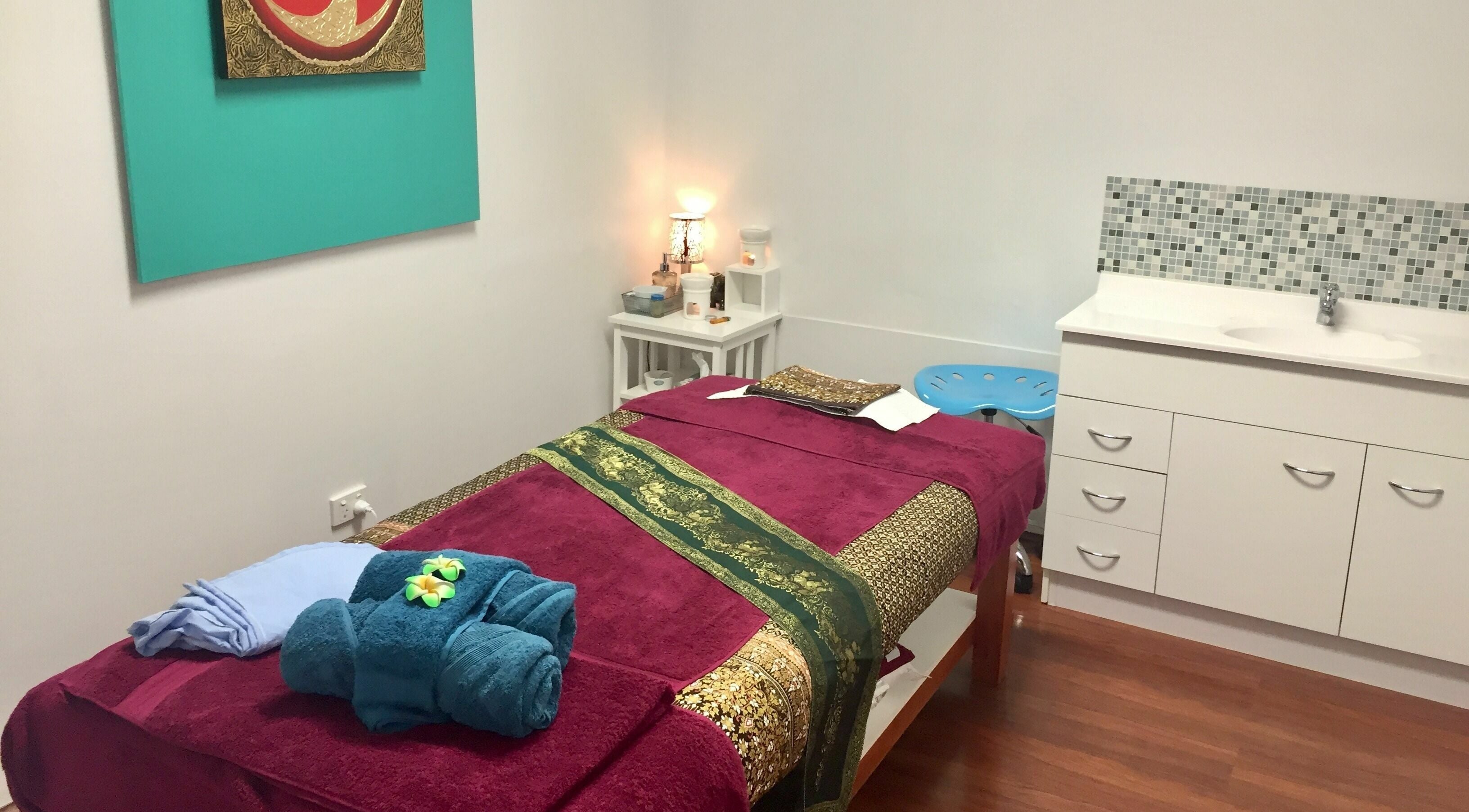 Relaxing treatment room at Sawadee Morisset in Morisset, New South Wales, AU with cozy decor and massage bed.
