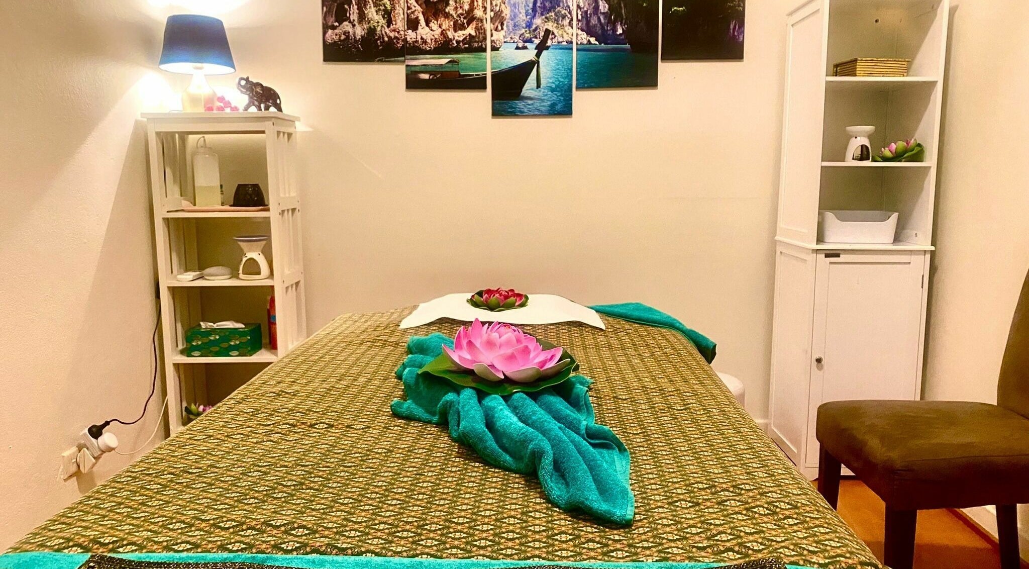 Tranquil massage room at Sawadee Broadmeadow in Broadmeadow, New South Wales, AU with lotus decor and soft lighting.