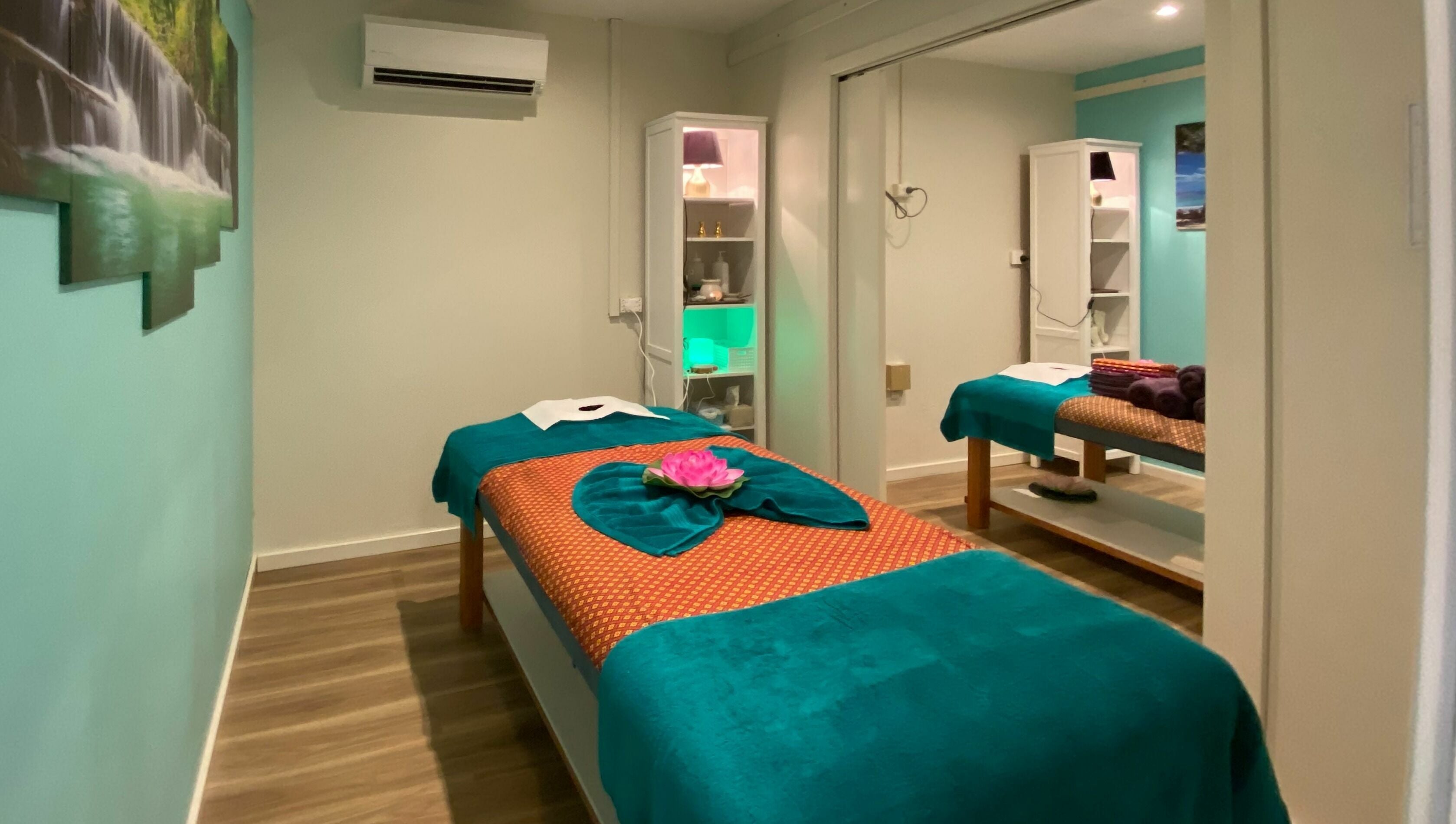 Tranquil massage room at Sawadee Cardiff, Cardiff, New South Wales, AU, with green and white decor.