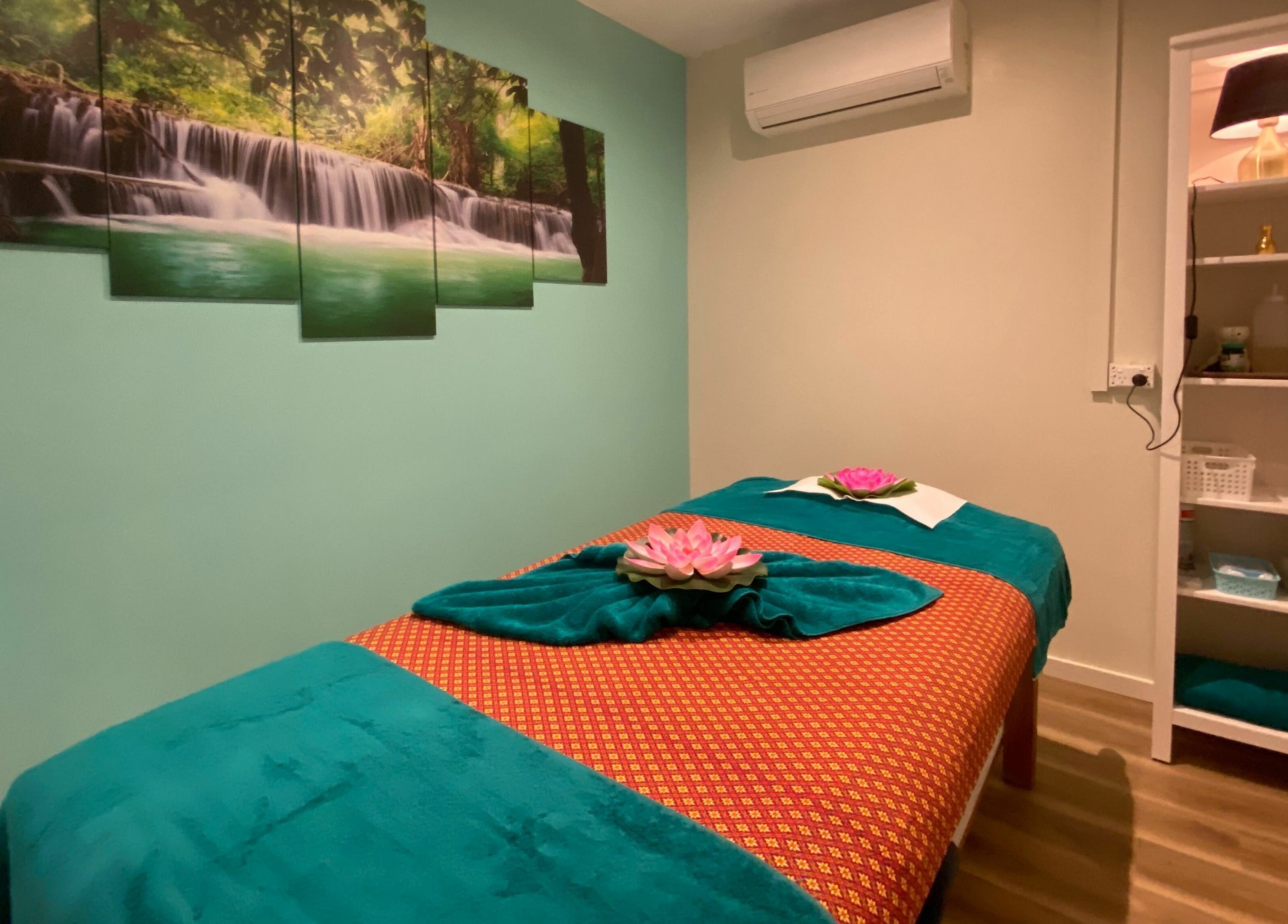 Serene massage room at Sawadee Cardiff in Cardiff, New South Wales, AU, with calming waterfall artwork.