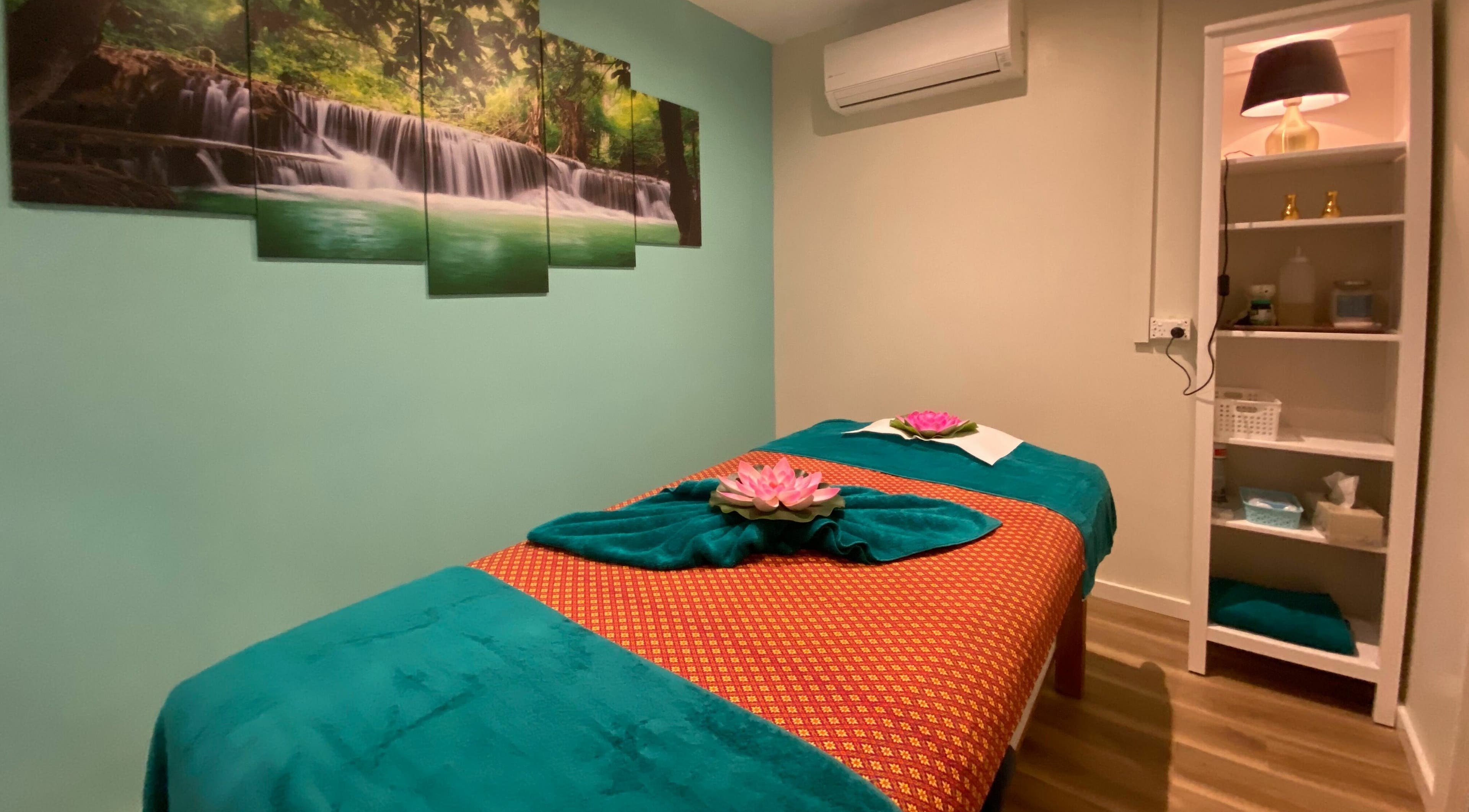 Serene massage room at Sawadee Cardiff in Cardiff, New South Wales, AU, with calming waterfall artwork.
