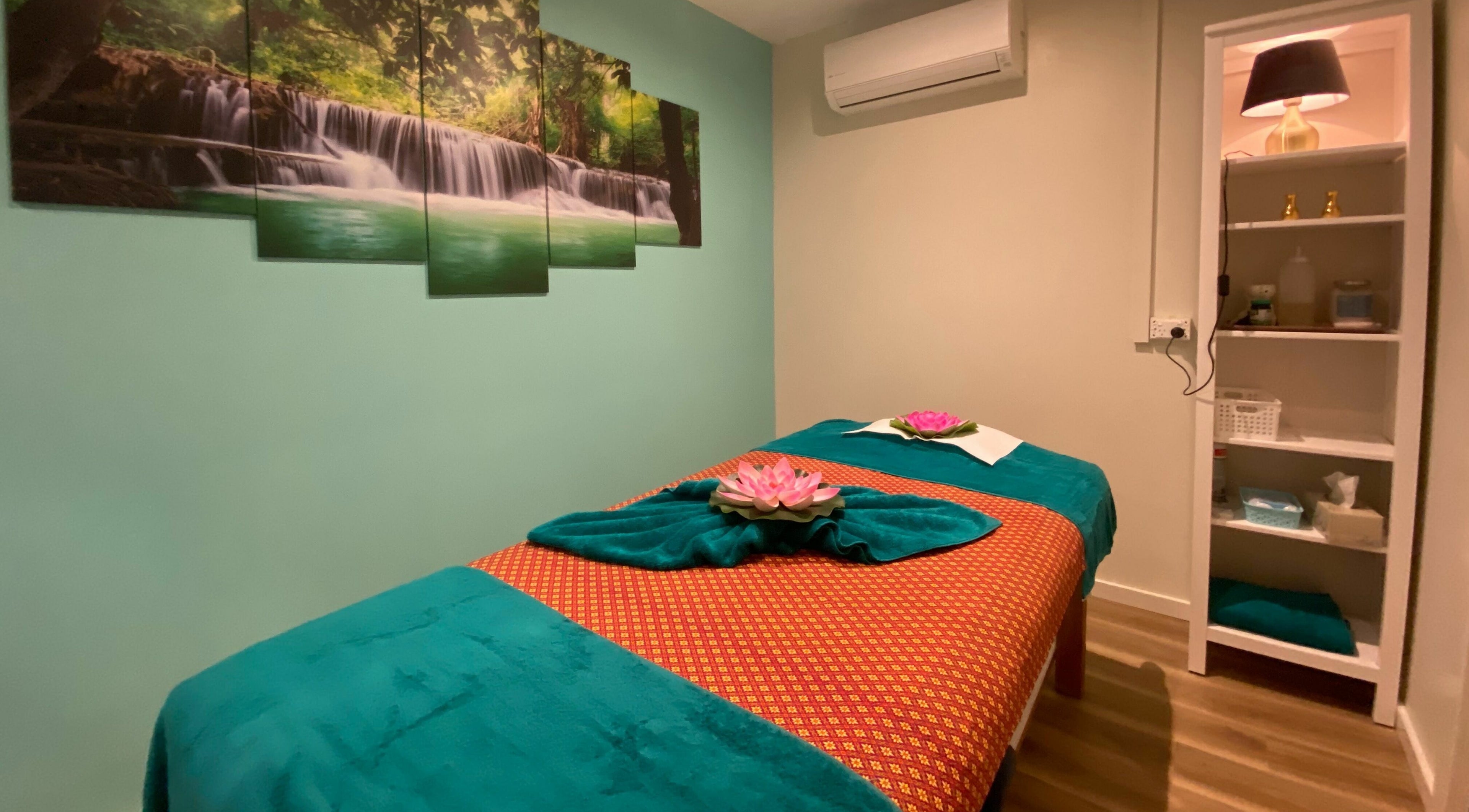 Serene massage room at Sawadee Cardiff in Cardiff, New South Wales, AU, with calming waterfall artwork.