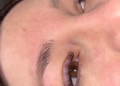 Close-up of well-groomed eyebrow and glowing skin at The Beauty Box, North Sunderland, England, GB.