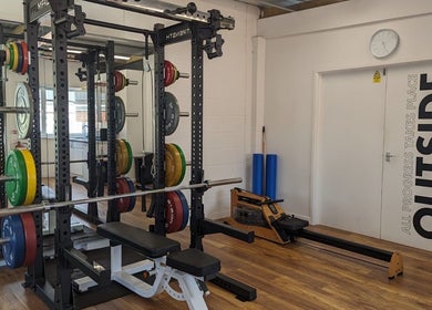 Weight racks and rowing machine at Exe Fitness, Exmouth, England, GB. Modern and motivational workout space.