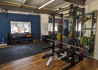 Modern gym setup at Exe Fitness, Exmouth, England, GB featuring weights and exercise equipment.