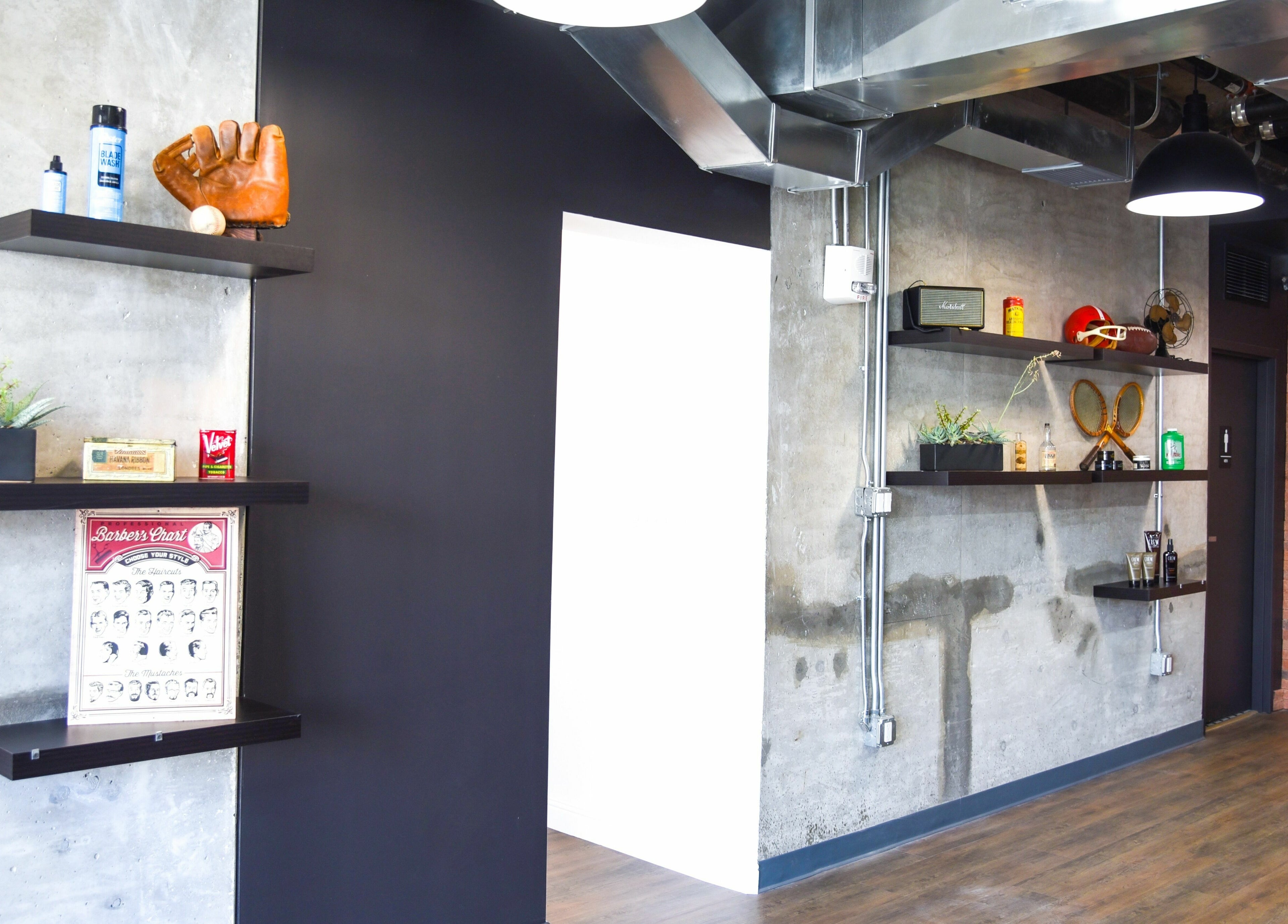 Chic industrial decor at Men's Grooming Salon SKY in Honolulu, Hawaii, US, featuring stylish wall shelves.