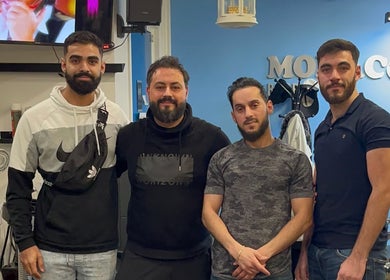 Team at Monaco Cuts, a vibrant barber shop in Hamilton, Ontario, CA.