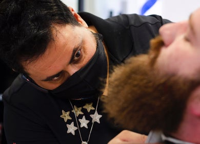 Expert barber grooming a beard at Monaco Cuts, Hamilton, Ontario, CA, enhancing style and confidence.