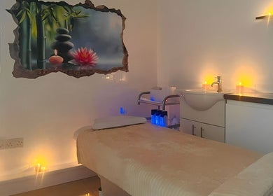 Tranquil treatment room at Mi Vida Aesthetic Clinic, Twickenham, England, GB with soft lighting and artwork.