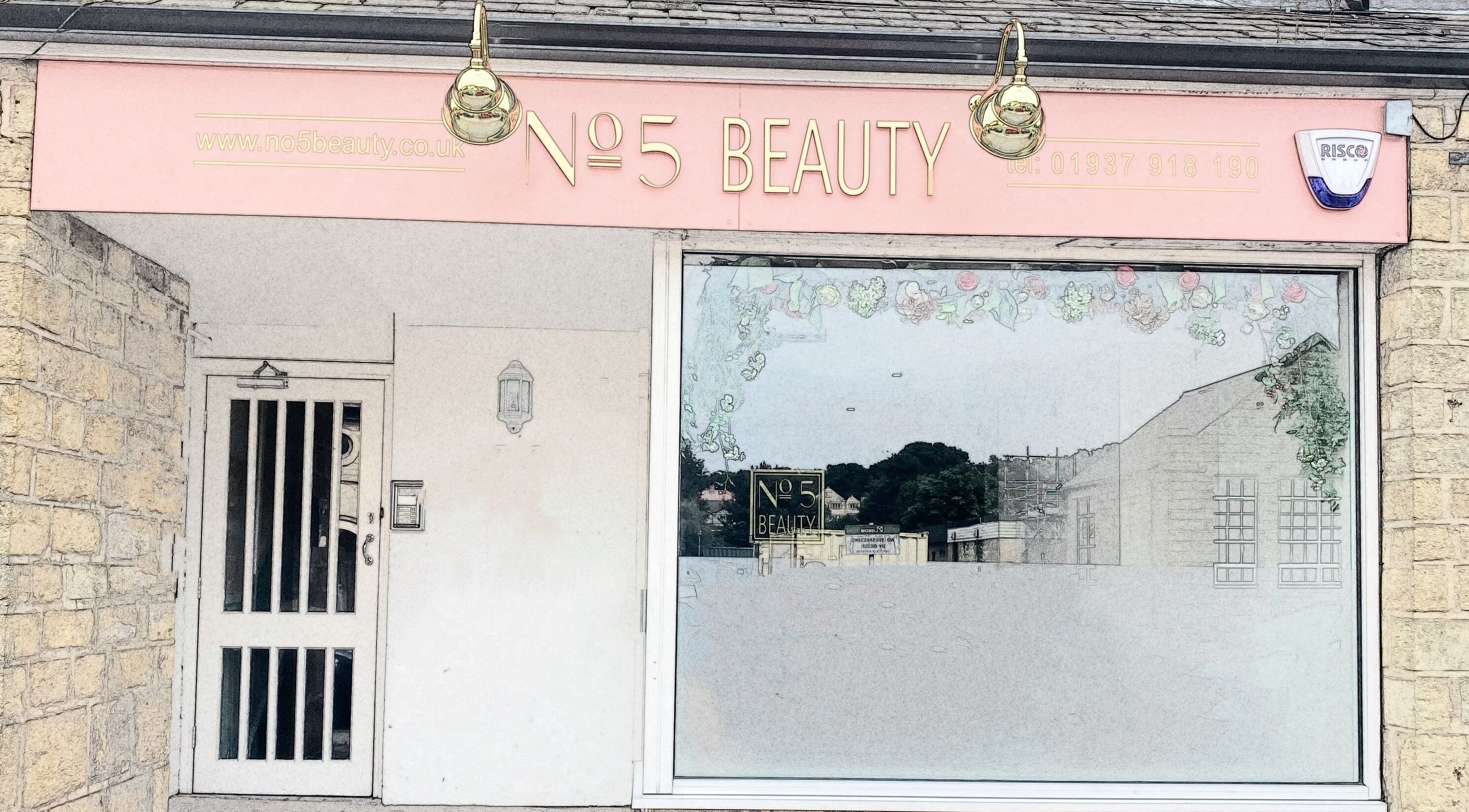 Front view of No 5 Beauty salon, Wetherby, England. Elegant glass window with floral decor.